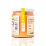 12 oz Sauce Bae Hot Raw Honey jar placed on a white backdrop, showing back side of jar.