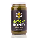 Sauce Bae Matcha Raw Honey on white backdrop with reflection. Unfiltered and unpasteurized raw honey.