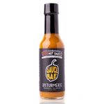 Bottle of Sauce Bae Hotter Habanero hot sauce with turmeric, featuring a black label with the Sauce Bae logo, 5 fl oz. This low-sodium, all-natural hot sauce offers a hint of sweetness with an even hotter kick from ghost pepper. Perfect for health-conscious spice lovers.