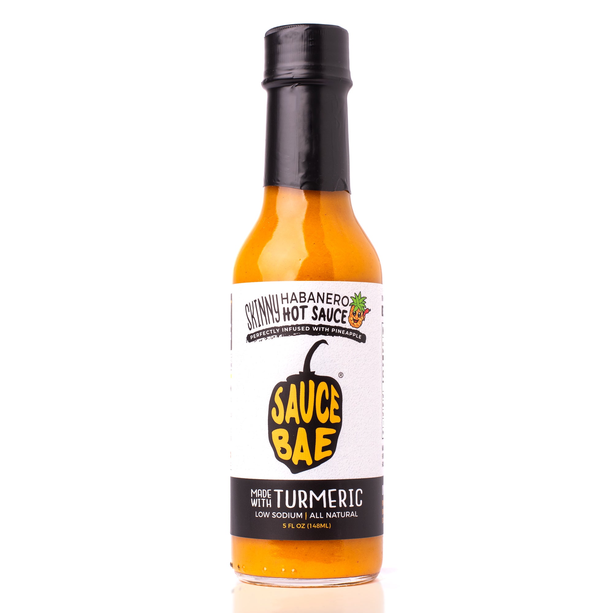 Front view of a 5 oz bottle of Sauce Bae Skinny Habanero Hot Sauce with turmeric, featuring a black and white label, yellow pepper logo, and a small pineapple icon.