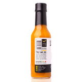 Side view of Sauce Bae Skinny Habanero Hot Sauce bottle showing barcode, medium heat rating of 4.5 out of 10, suggested food pairings, and flavor description: “Hint of sweetness with the perfect kick.”