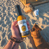 Sauce Bae Skinny Habanero Hot Sauce Being Held At The Beach
