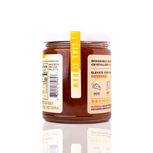 12 oz Sauce Bae Hot Raw Honey jar placed on a white backdrop, showing back side of jar.