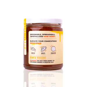 Sauce Bae crystallized raw honey jar, marketed as spoonable and perfect for charcuterie with cheese, meats, crackers.