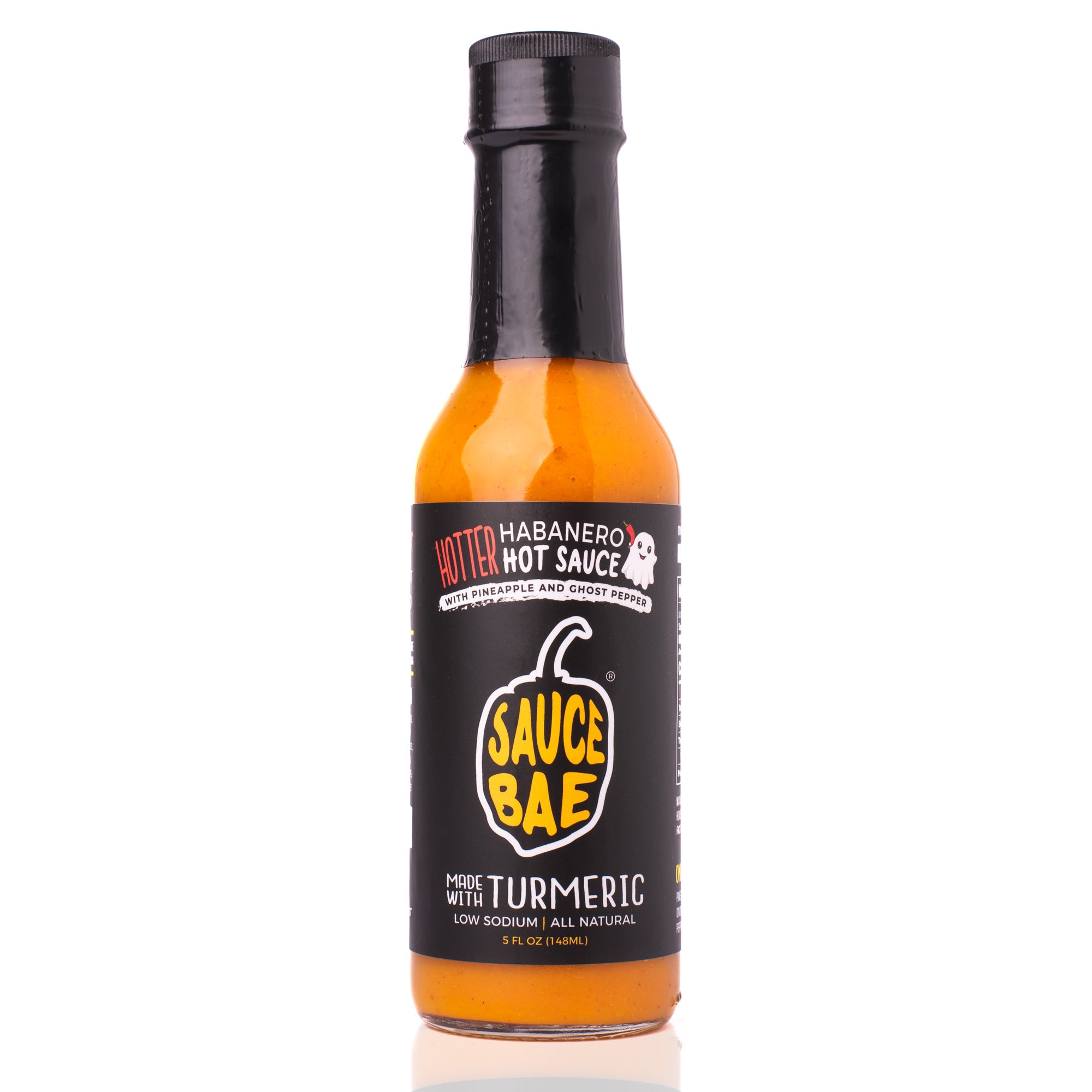 Front view of Sauce Bae Hotter Habanero Hot Sauce bottle featuring a black label with a yellow pepper logo, ghost pepper icon, and bold text highlighting turmeric, pineapple, and ghost pepper ingredients. 5 fl oz glass bottle with vibrant orange sauce inside, photographed on a white background.