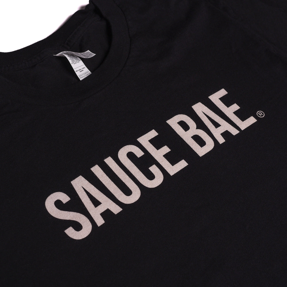 Close up view of Black Sauce Bae tee with text on the chest that reads Sauce Bae.