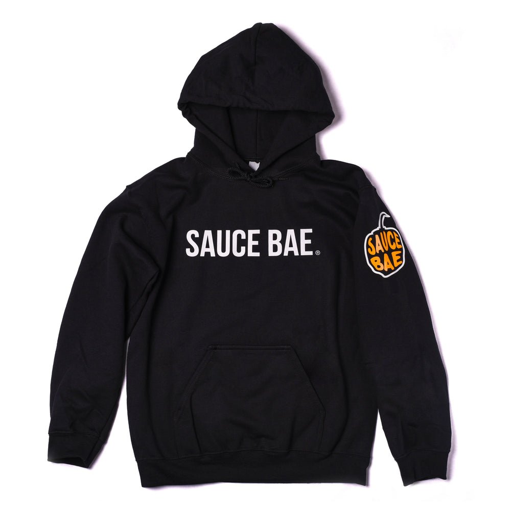 Front view of Sauce Bae black hoodie featuring Sauce Bae logo on chest and pepper logo on left sleeve. High-quality, cozy fabric.