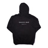 Back view of Sauce Bae black hoodie with 'Sauce Bae MMXVII' text in white. Classic design with a modern touch, representing the brand's establishment year.